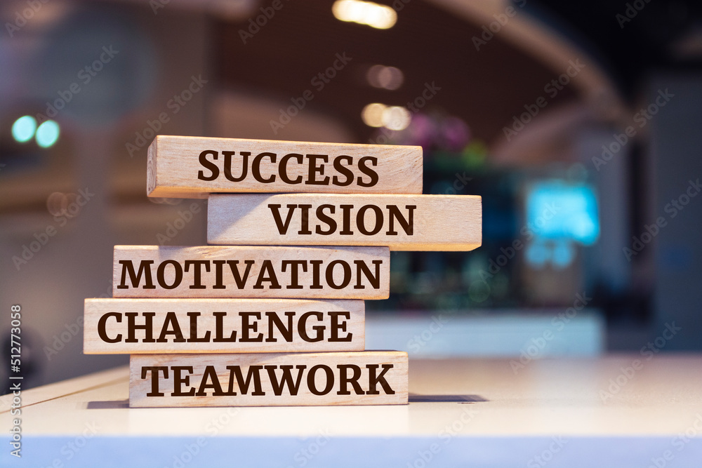 Wooden blocks with words 'success, vision, motivation, challenge, teamwork'. business concept.