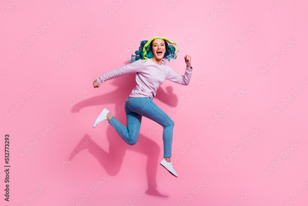 Full body photo of sporty overjoyed lady jump running rush fast have good mood isolated on pink color background