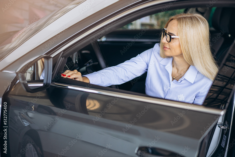 Buisness woman choosing a car in a car showroom