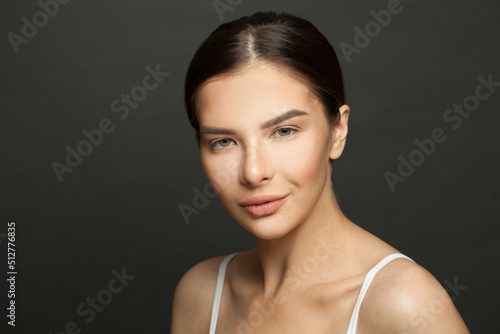 Beautiful young woman with clean fresh skin portrait. Beauty female face. Facial treatment and skin care.