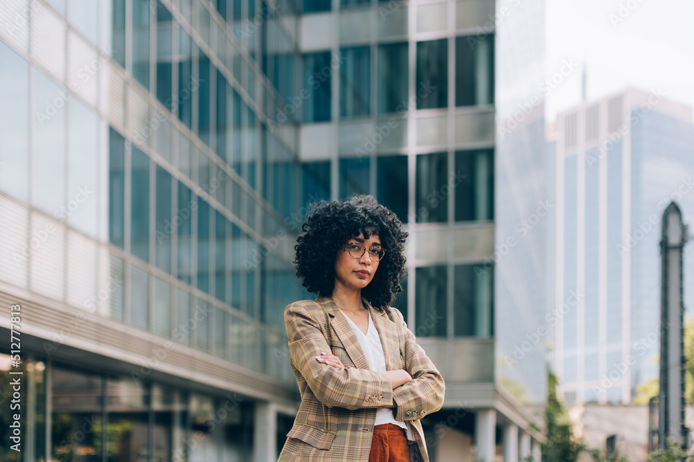 photograph of fashionable female businesswoman among the buildings of the financial district photograph of fashionable female businesswoman among the buildings of the financial district