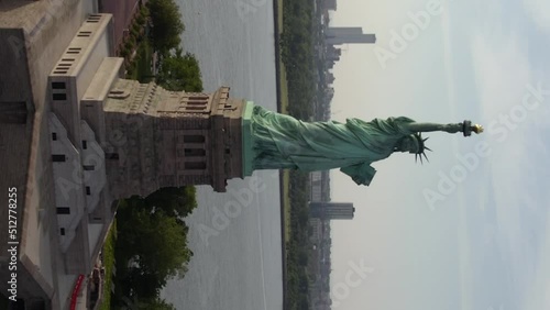Aerial view around the Statue of Liberty, in NYC, USA - Vertical, orbit, drone shot