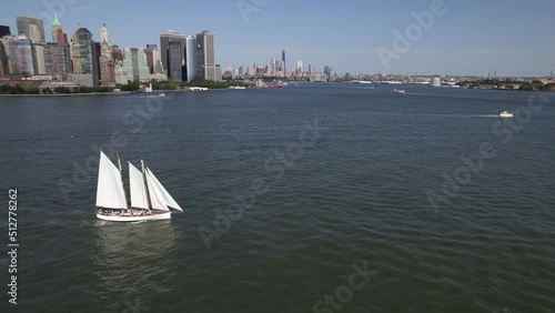 Aerial view around a sailboat in front of lower Manhattan, New York, USA - circling, drone shot photo