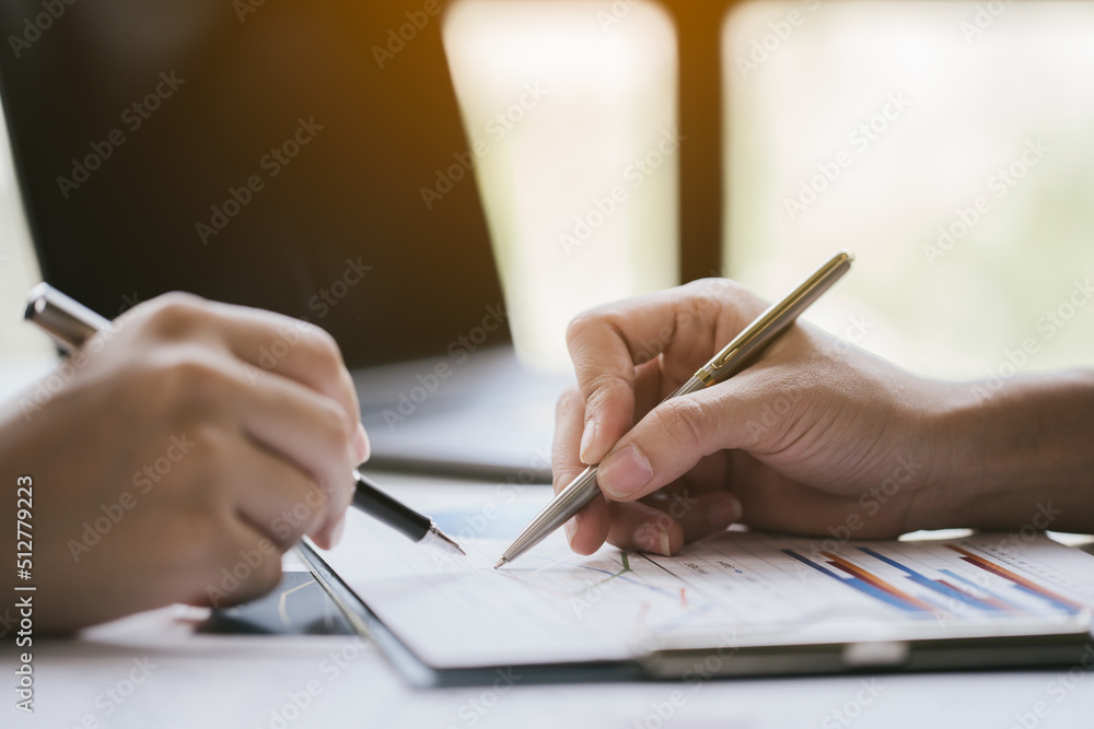 Close up of hands are working on paperworks that shows graft and chart of accounting and financial. Close up of hands are working on paperworks that shows graft and chart of accounting and financial.