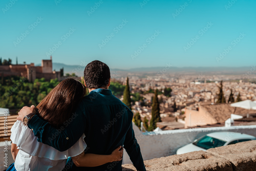 beautiful couple in love hugging and looking at the landscape