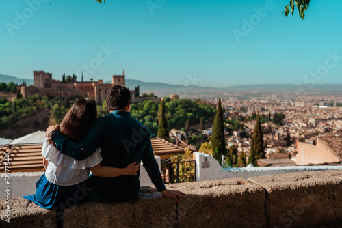 beautiful couple in love hugging and looking at the landscape