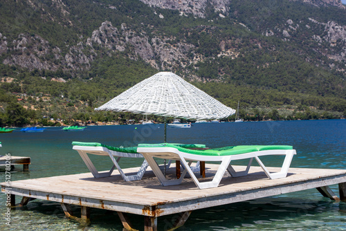 Sunbeds and umbrellas in the water on the beach
