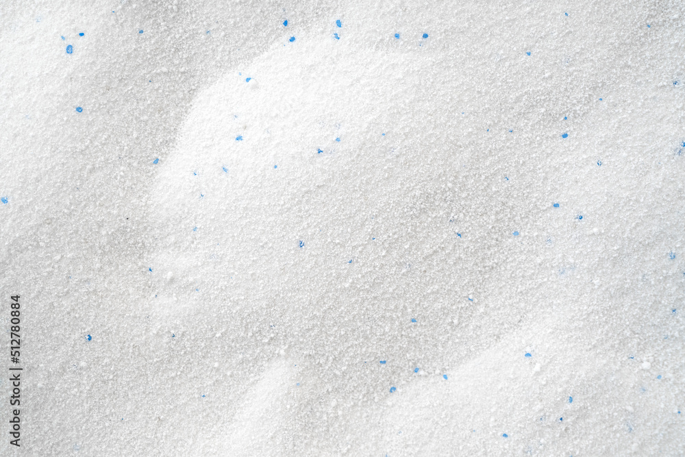 Сrumbly white washing powder as texture or background, top view Сrumbly white washing powder as texture or background, top view