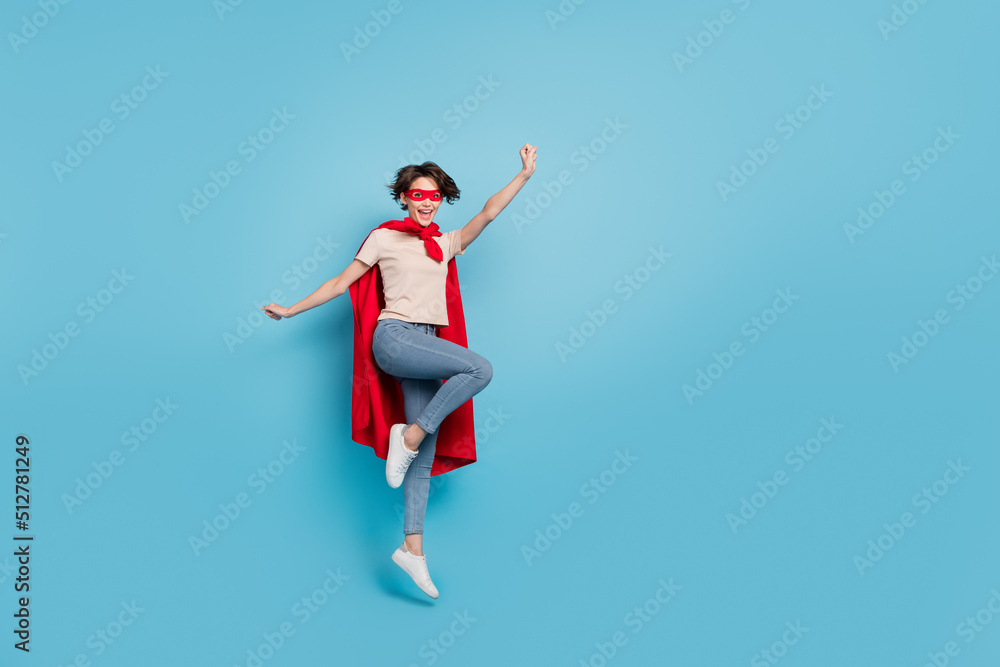 Full length photo of funny cute lady dressed red mantle jumping high empty space isolated blue color background