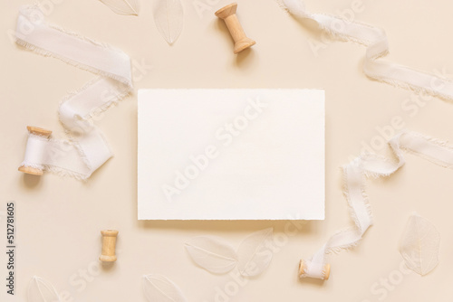 Wedding card near white silk ribbons on light yellow, mockup