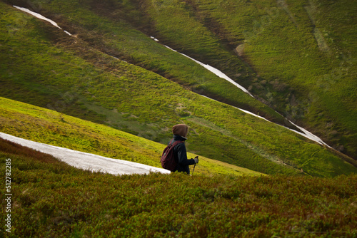 One traveler goes through mountain passes in the snow.