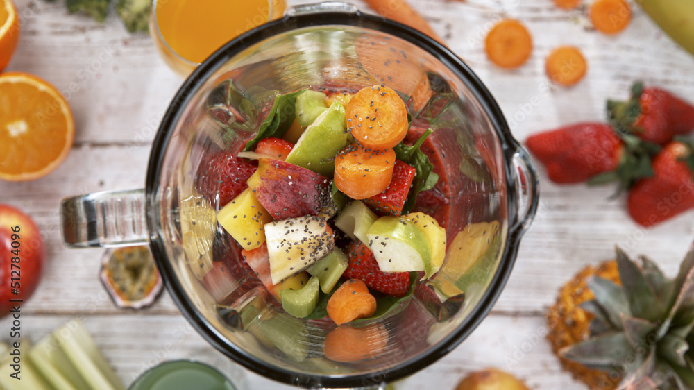 Fresh fruit and vegetables smoothie blended in blender, top view. Healthy eating concept. Fresh fruit and vegetables smoothie blended in blender, top view. Healthy eating concept.