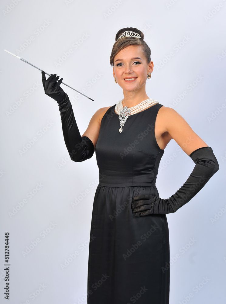 girl in a black dress with a cigarette in the mouthpiece girl in a black dress with a cigarette in the mouthpiece