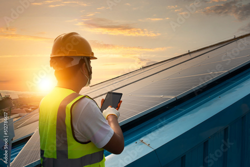 Technician inspecting solar panel maintenance on hospital roof, solar panel maintenance view photo