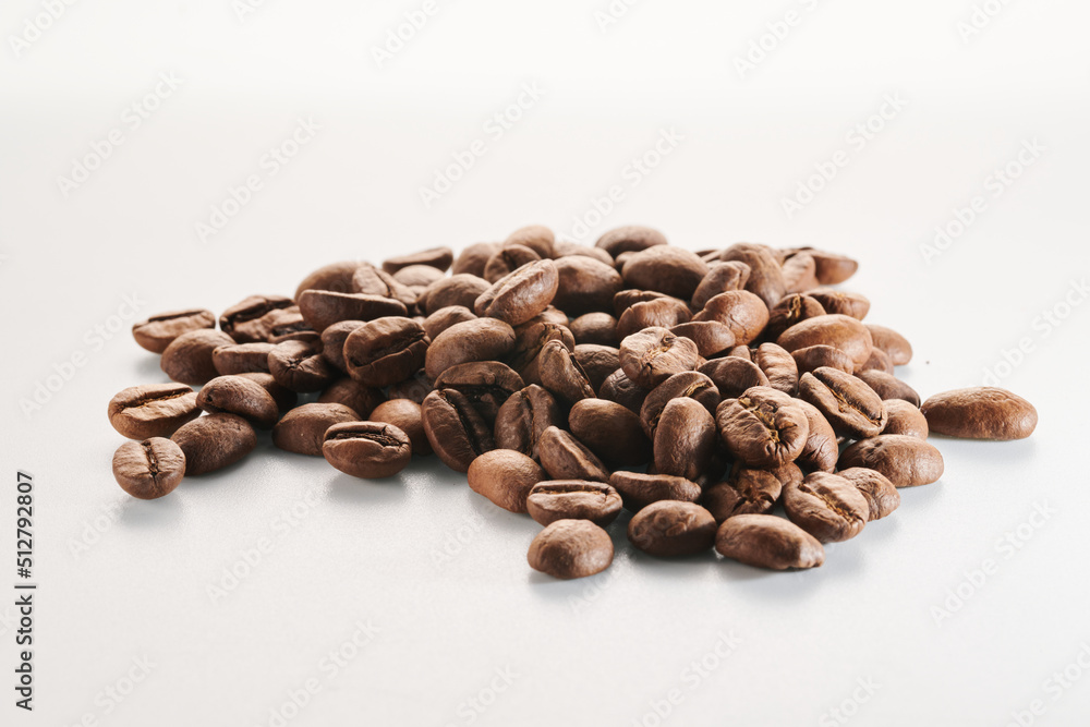 Roasted coffee beans isolated close up on white background, clipping path Roasted coffee beans isolated close up on white background, clipping path