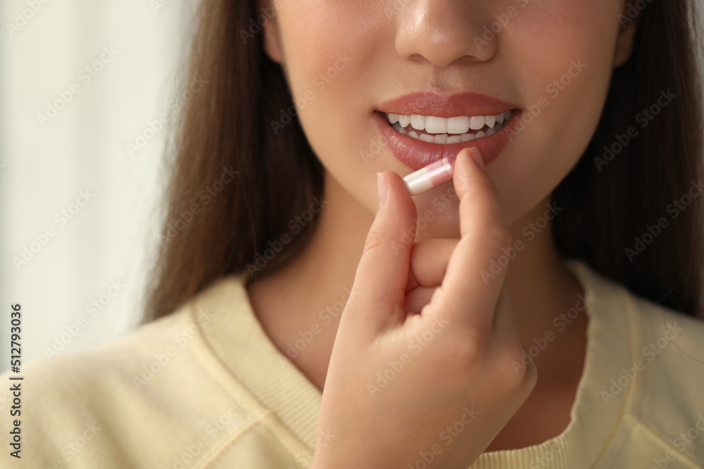 Young woman taking dietary supplement pill, closeup Young woman taking dietary supplement pill, closeup