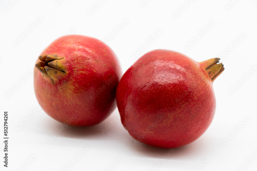 Fototapeta premium Fresh whole pomegranate closeup isolated on white background