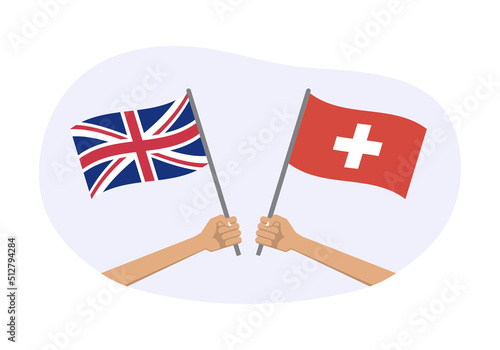 UK and Switzerlanda flags. Swiss and British national symbols. Hand holding waving flag. Vector illustration. photo