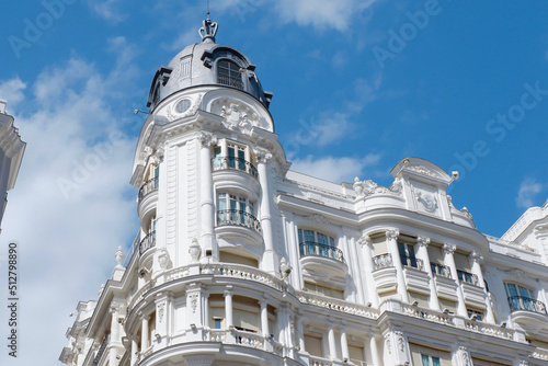 Corner of elegant old building with rounded forms in balconies and structure in centre of Madrid, Spain. Stunning Spanish architectural style