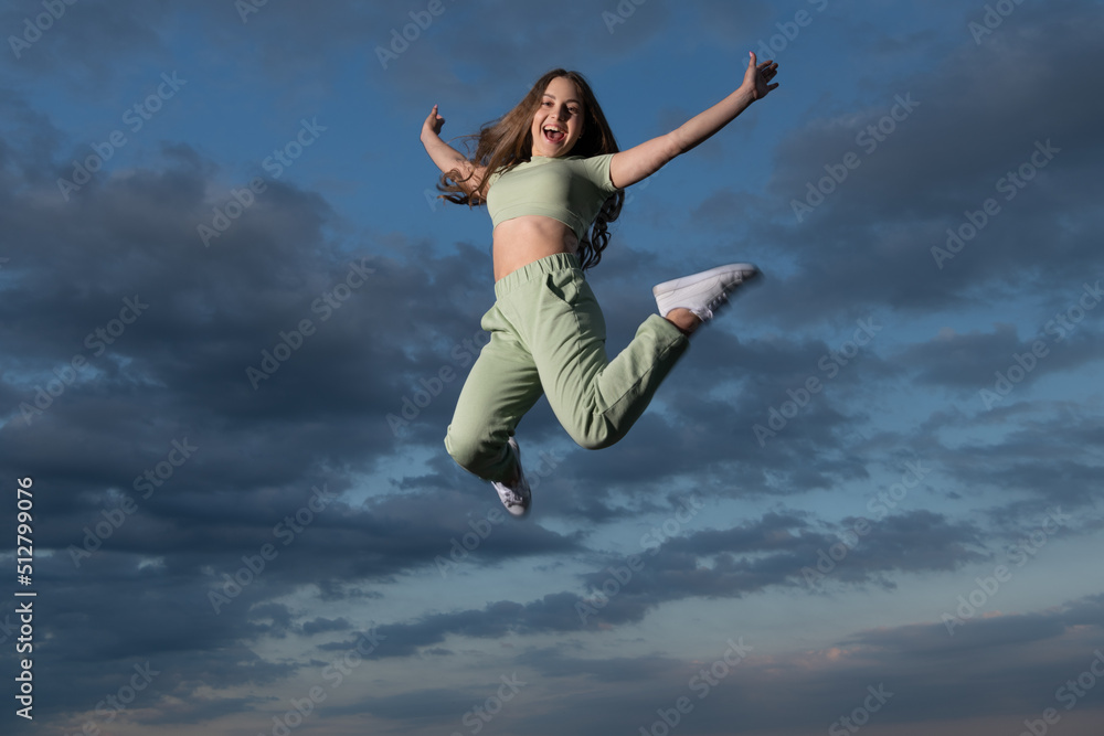 happy teen girl jumping high on sky background happy teen girl jumping high on sky background