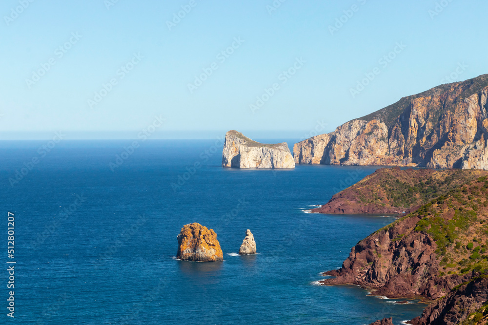 Cliff landscape in the mediterranean sea with different colors in the village of Nebida, Sardinia, Italy Cliff landscape in the mediterranean sea with different colors in the village of Nebida, Sardinia, Italy
