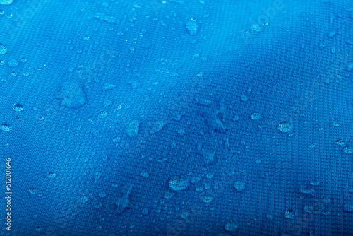 Water repellent fabric, waterdrops on blue waterproof surface
