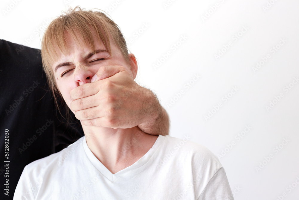 a woman covers her mouth with her hand. domestic violence. abuse a woman covers her mouth with her hand. domestic violence. abuse