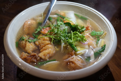 Delicious seafood Tom Yum soup. Tom yum or tom yam is a type of hot and sour Thai soup, usually cooked with Seafood. Soft focus, high angle view image.