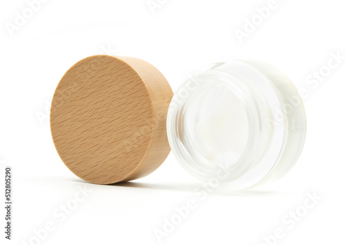 Open mini empty glass container with wood lid isolated on white background