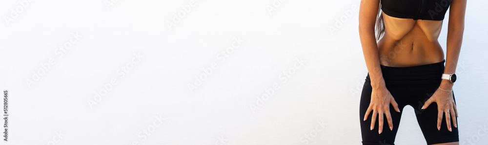 Young slim woman is doing breathing exercises. Home sports training. Belly vacuum. Banner with place for text. Healthy lifestyle. Vacuum yoga gymnastics for the abdomen. Nauli. Press muscle. Young slim woman is doing breathing exercises. Home sports training. Belly vacuum. Banner with place for text. Healthy lifestyle. Vacuum yoga gymnastics for the abdomen. Nauli. Press muscle.