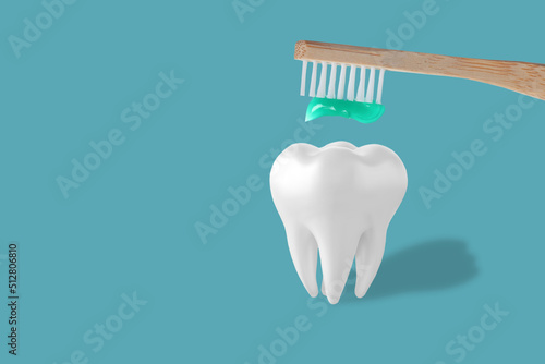 Holding toothpaste and toothbrush near tooth model on blue background. People teeth hygiene. Empty place for text, quote, sayings or logo. Closeup. Dental concept.