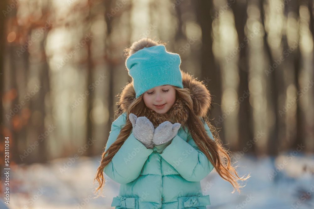 little girl blows on the snow that is on her mittens little girl blows on the snow that is on her mittens