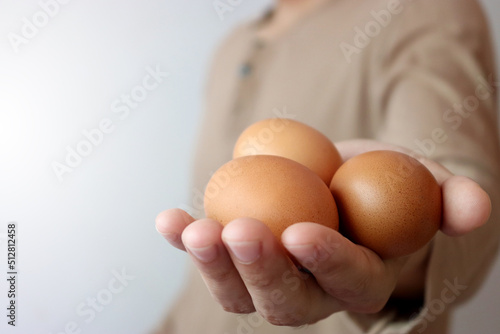 Brown egg in the hands of farmers. © SURASIT