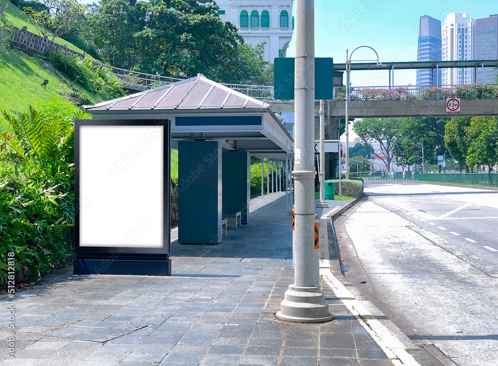 Blank vertical advertising poster banner mockup at bus stop shelter by main road, at city centre; out-of-home OOH billboard media display space. clarke quay area. Blank vertical advertising poster banner mockup at bus stop shelter by main road, at city centre; out-of-home OOH billboard media display space. clarke quay area.