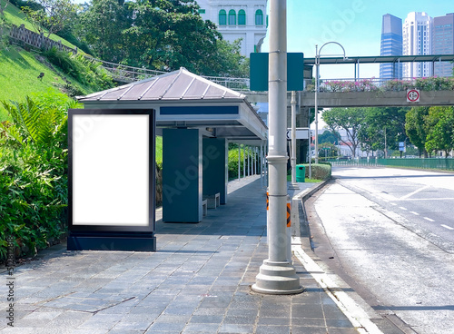Canvas Print Blank vertical advertising poster banner mockup at bus stop shelter by main road, at city centre; out-of-home OOH billboard media display space