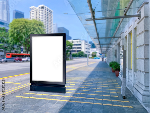 Blank vertical advertising poster banner mockup at bus stop shelter by main road, at city centre; out-of-home OOH billboard media display space. clarke quay area.