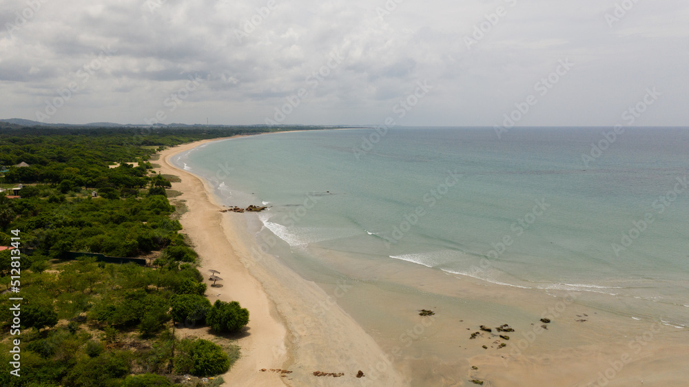 Aerial view of Tropical sandy beach and blue sea. Sri Lanka. Summer and travel vacation concept.