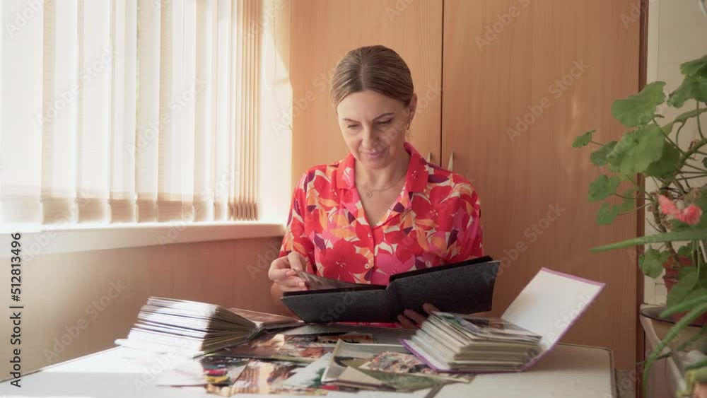 Woman historian, middle-aged, carefully studies archival photographs, digs into historical facts. 4k video. Woman historian, middle-aged, carefully studies archival photographs, digs into historical facts. 4k video.
