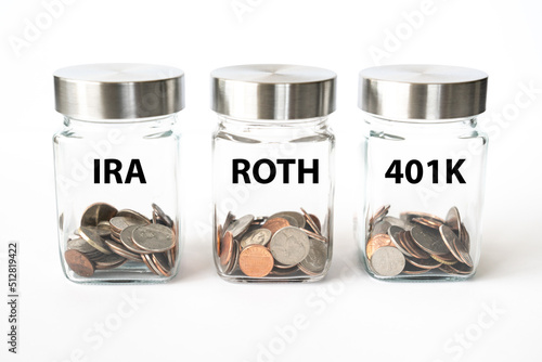 Jars with coins for retirement savings in Roth, 401K and IRA accounts photo
