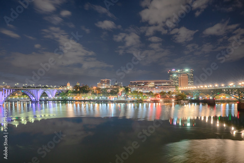 The city skyline of Knoxville along the Tennessee River at night