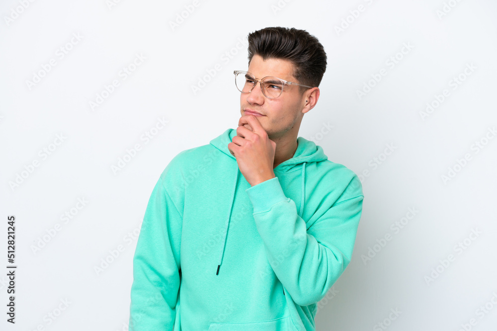 Young handsome caucasian man isolated on white bakcground and looking up Young handsome caucasian man isolated on white bakcground and looking up