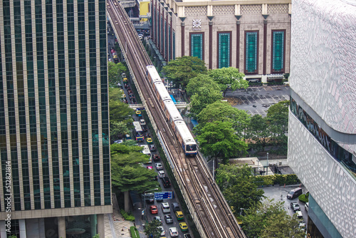 Photography Phloen Chit Road,Pathum Wan,Bangkok,Thailand on March16,2019:BTS Skytrain(The Bangkok Mass Transit System) passing Central Chidlom shopping mall building