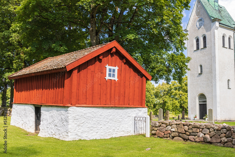 Fototapeta premium Old shed by a church steeple