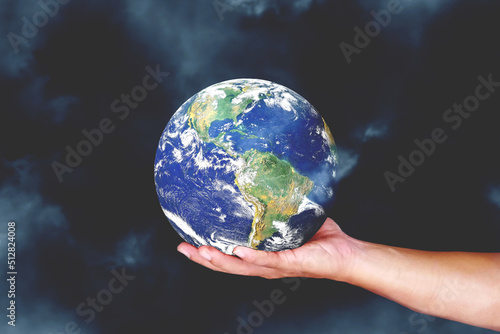 Globe in hand. The concept of loving the earth, saving the environment.