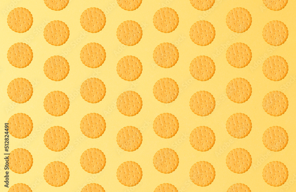 The concept of minimalism. Cookie pattern on a yellow background. Horizontal space for copying. Close-up. Top view The concept of minimalism. Cookie pattern on a yellow background. Horizontal space for copying. Close-up. Top view