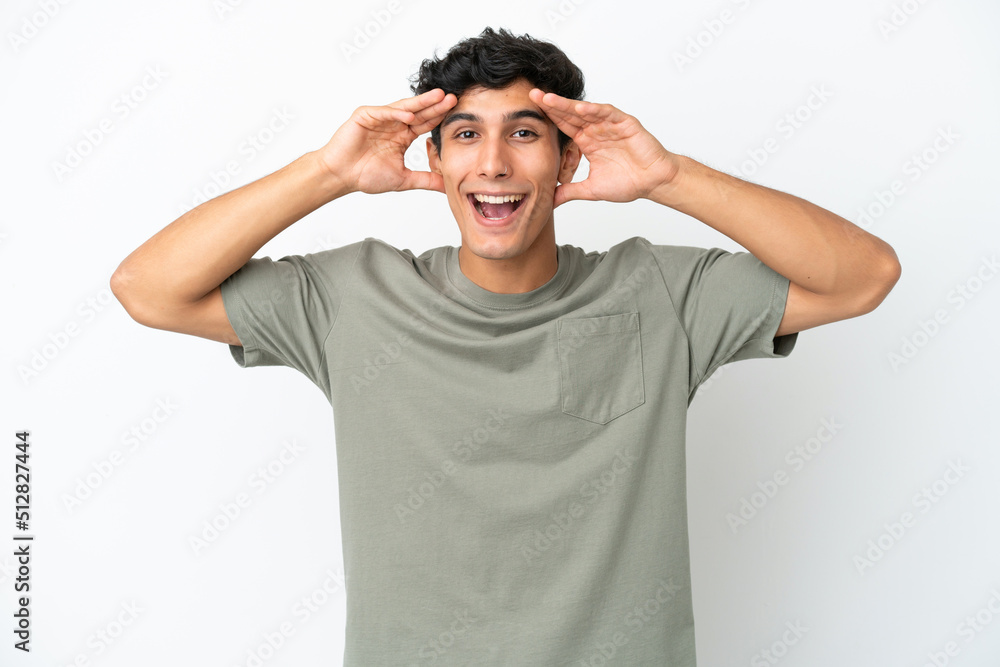 Young Argentinian man isolated on white background with surprise expression Young Argentinian man isolated on white background with surprise expression