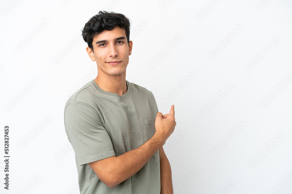 Young Argentinian man isolated on white background pointing back Young Argentinian man isolated on white background pointing back