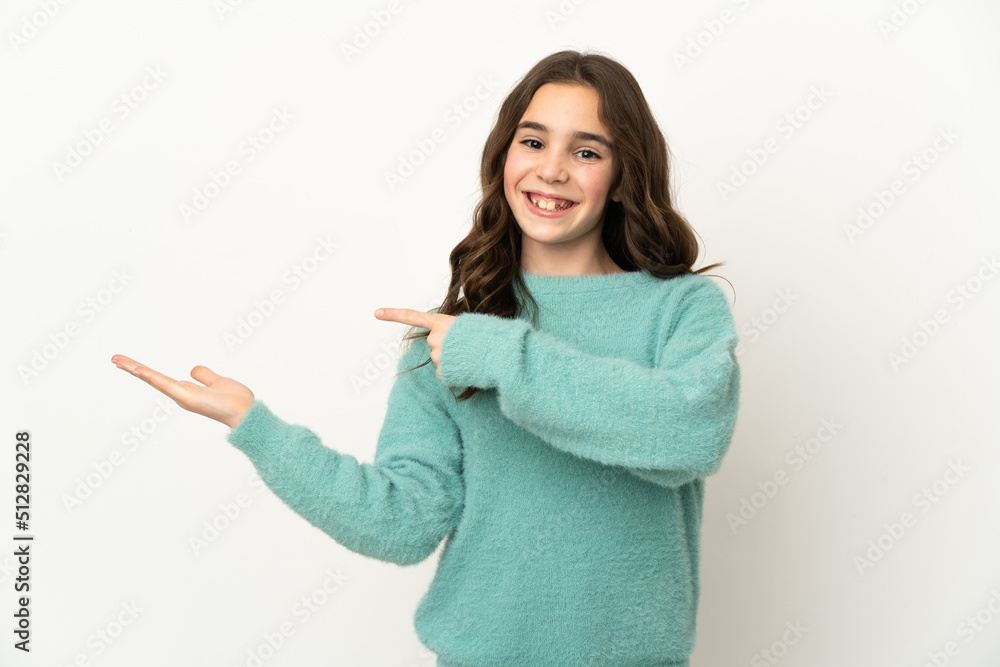 Little caucasian girl isolated on white background holding copyspace imaginary on the palm to insert an ad Little caucasian girl isolated on white background holding copyspace imaginary on the palm to insert an ad