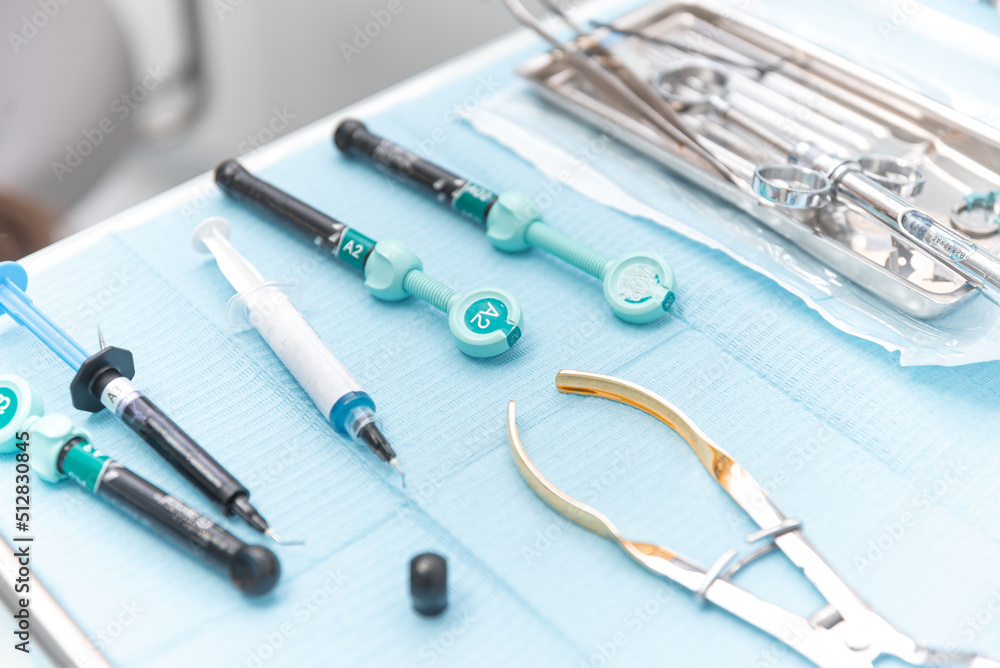 Photo of a set of steril dentistry tools or instruments lying on a table. Photo of a set of steril dentistry tools or instruments lying on a table.