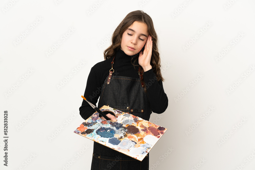 Little artist girl holding a palette isolated on white background with headache Little artist girl holding a palette isolated on white background with headache